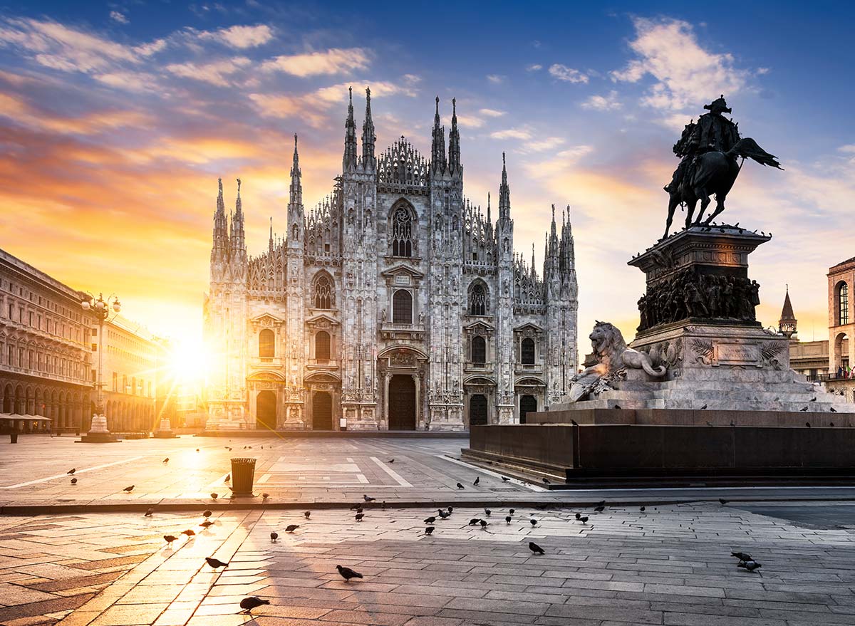 The sun rising on a cathedral in Milan, Italy