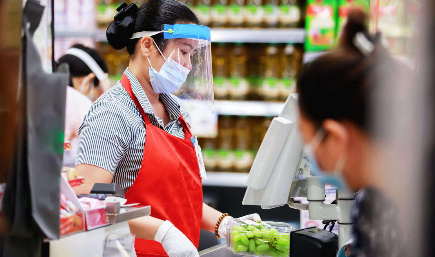 grocery store clerk with a mask