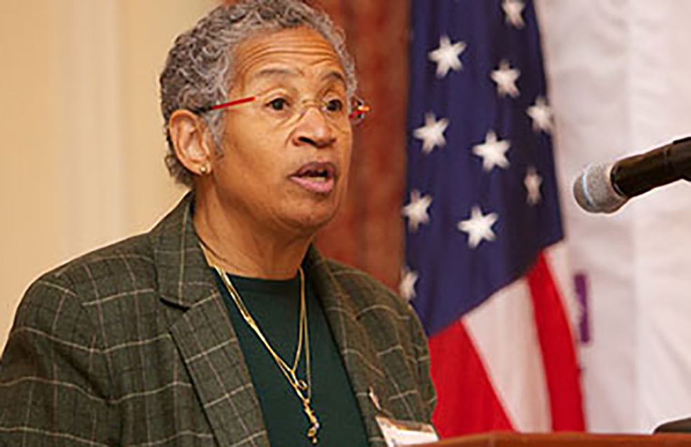 Deborah A. Batts standing in front of an American flag
