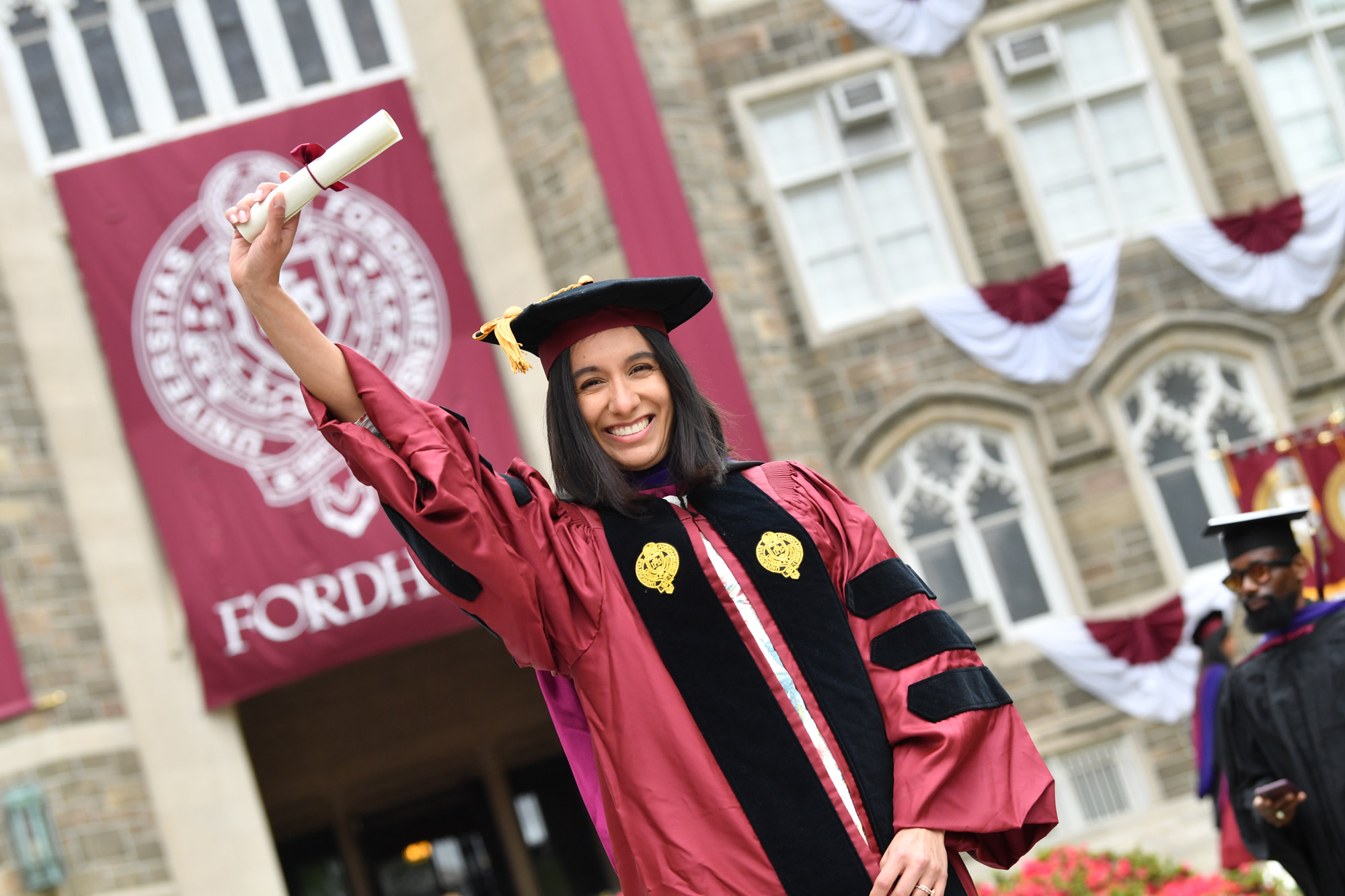 graduate holding her degree