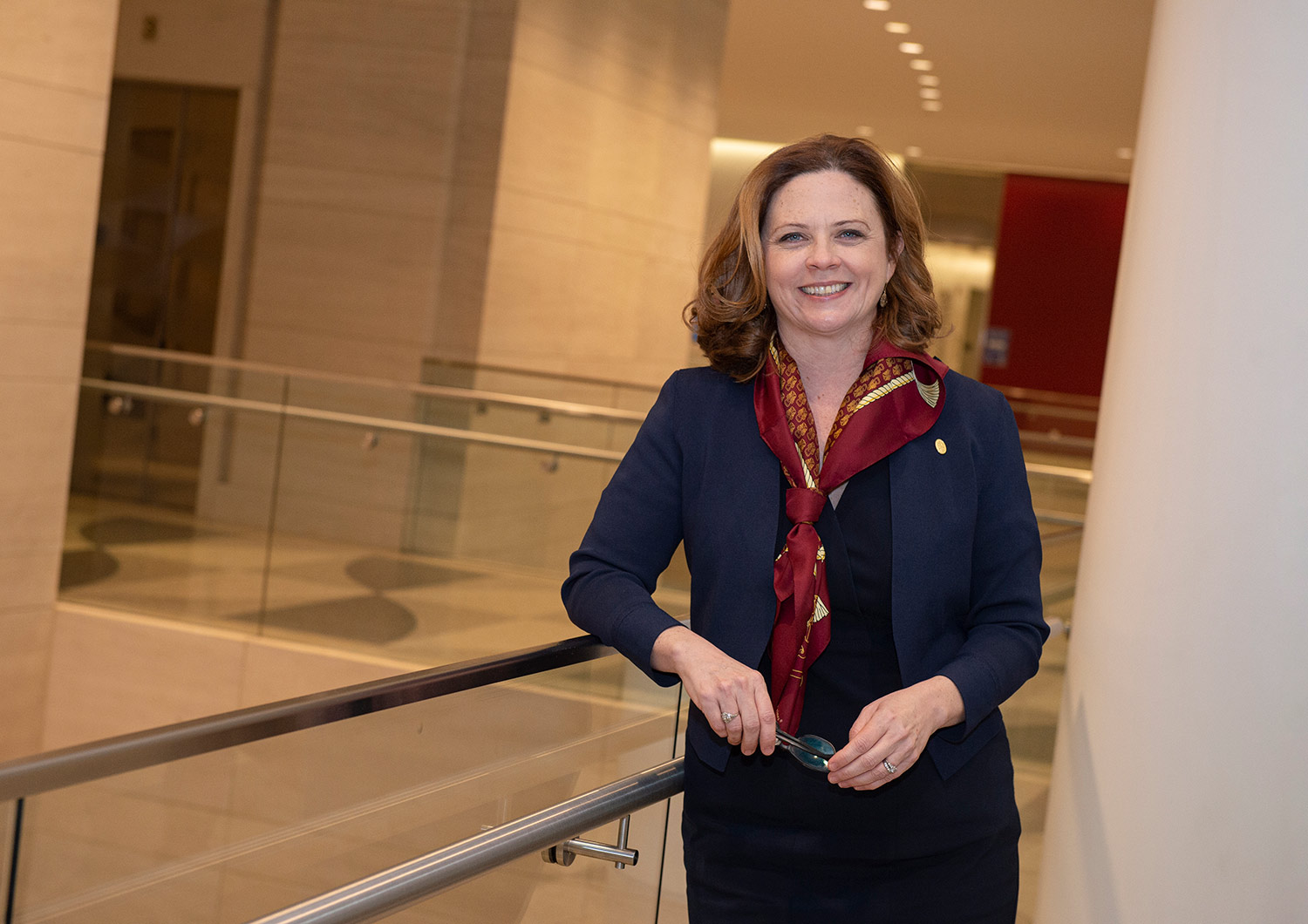 A landscape photograph perspective of Tania Tetlow (Fordham University's 33rd President) smiling as she poses for a picture