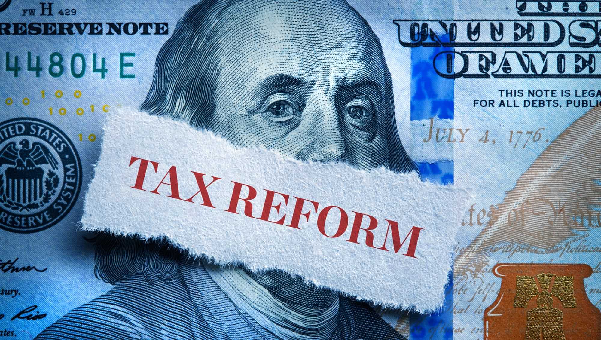 Tax Reform typography over a close up of Benjamin Franklin on a 100 dollar bill