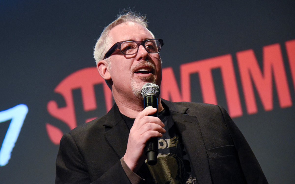 Brian Koppelman holding and speaking into a microphone