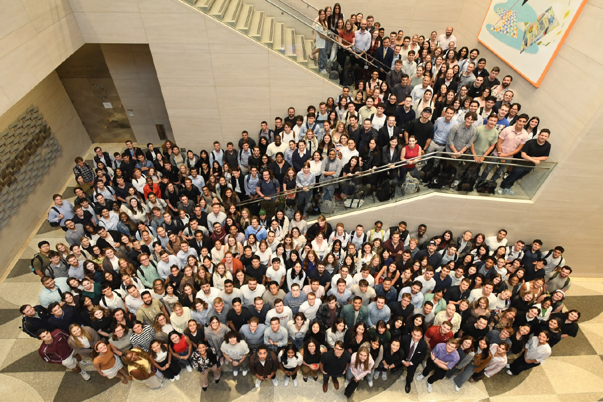 hall filled with students smiling toward camera