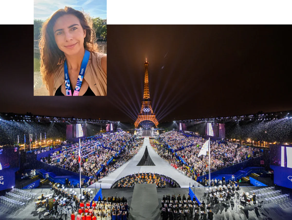 Aude Sainte-Rose wearing 2024 Paris Olympics lanyard; view of the Eiffel Tower near the 2024 Paris Olympic stadium