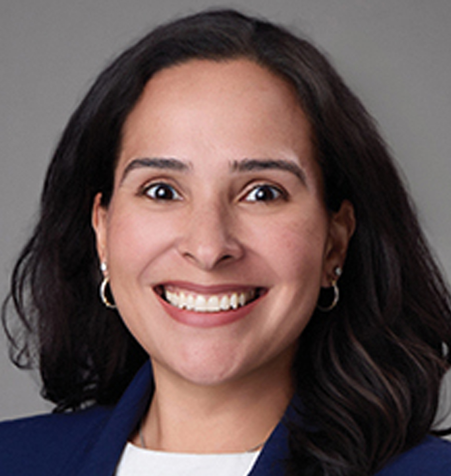 Headshot of Diana Santos smiling in a navy blue business blazer suit