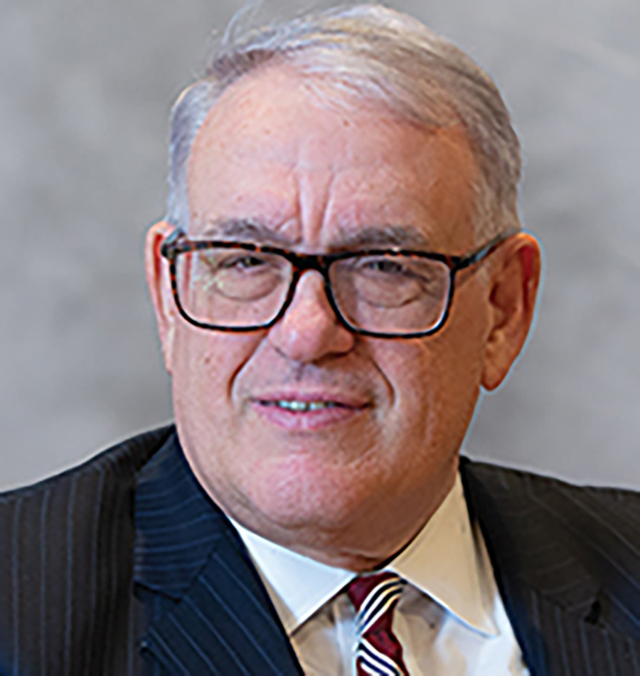 Headshot of Hon. John J. Leo smiling in a black blazer business suit