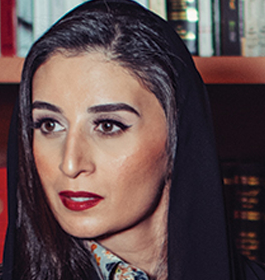 Headshot of Maha Bin Hendi with red lipstick and a black headdress scarf