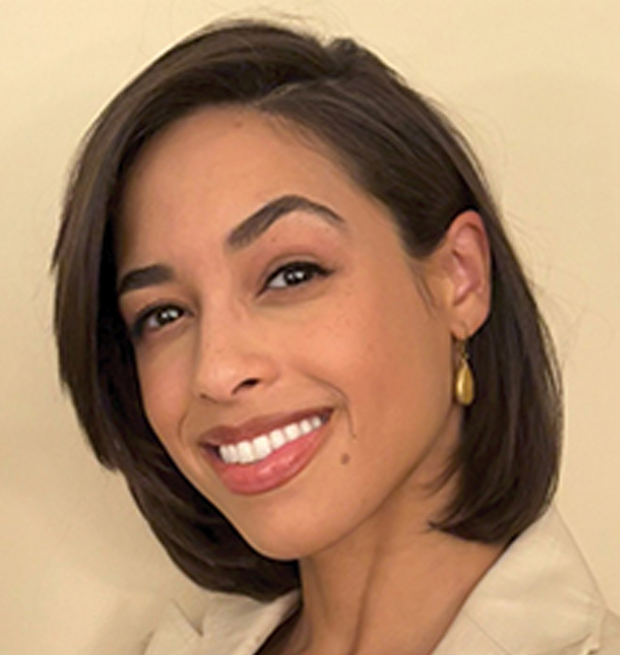 Headshot of Nadjia Bailey smiling in a tan business blazer suit
