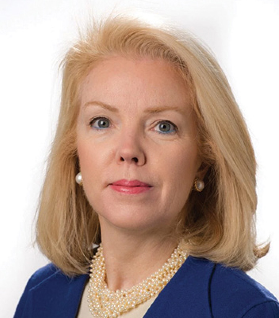 Headshot of Rose Gill grinning in a blue business blazer suit