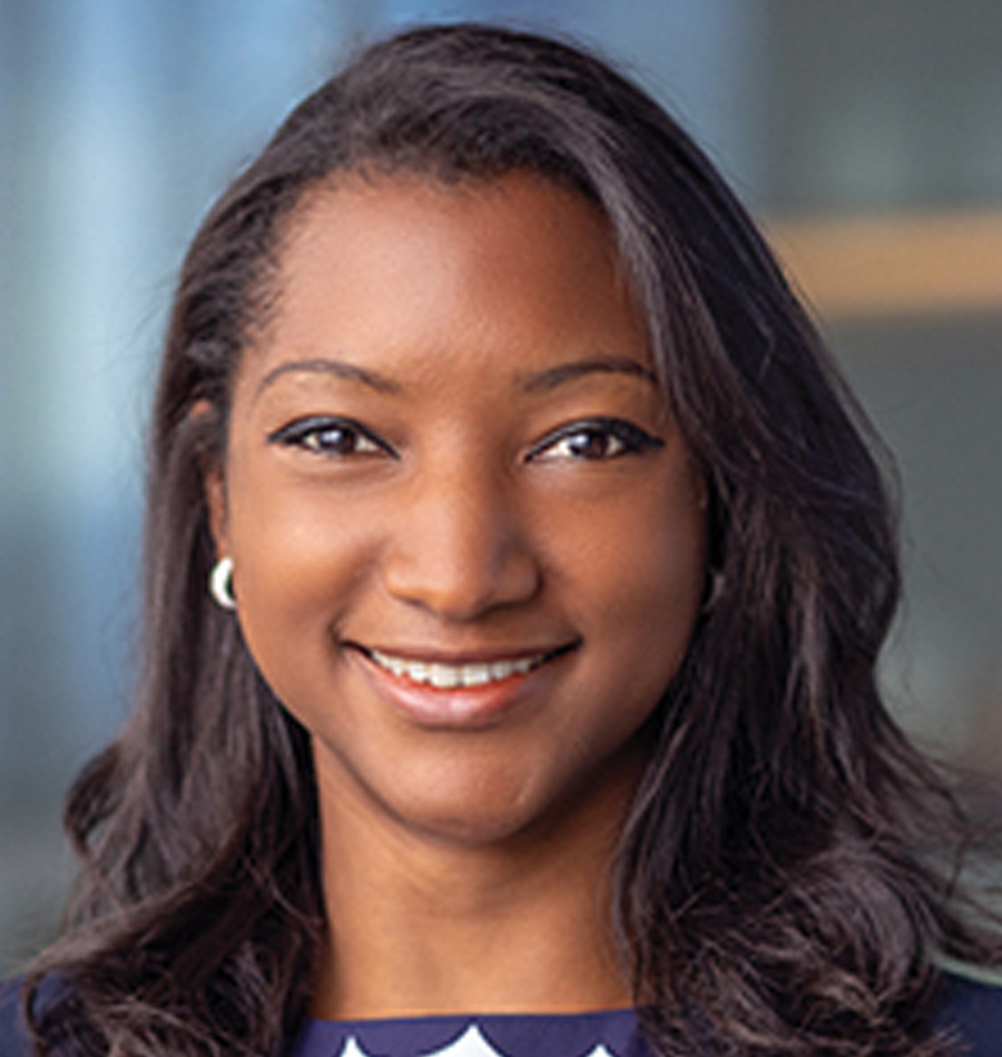 Headshot of Séverine Losembe smiling in a navy blue blouse top