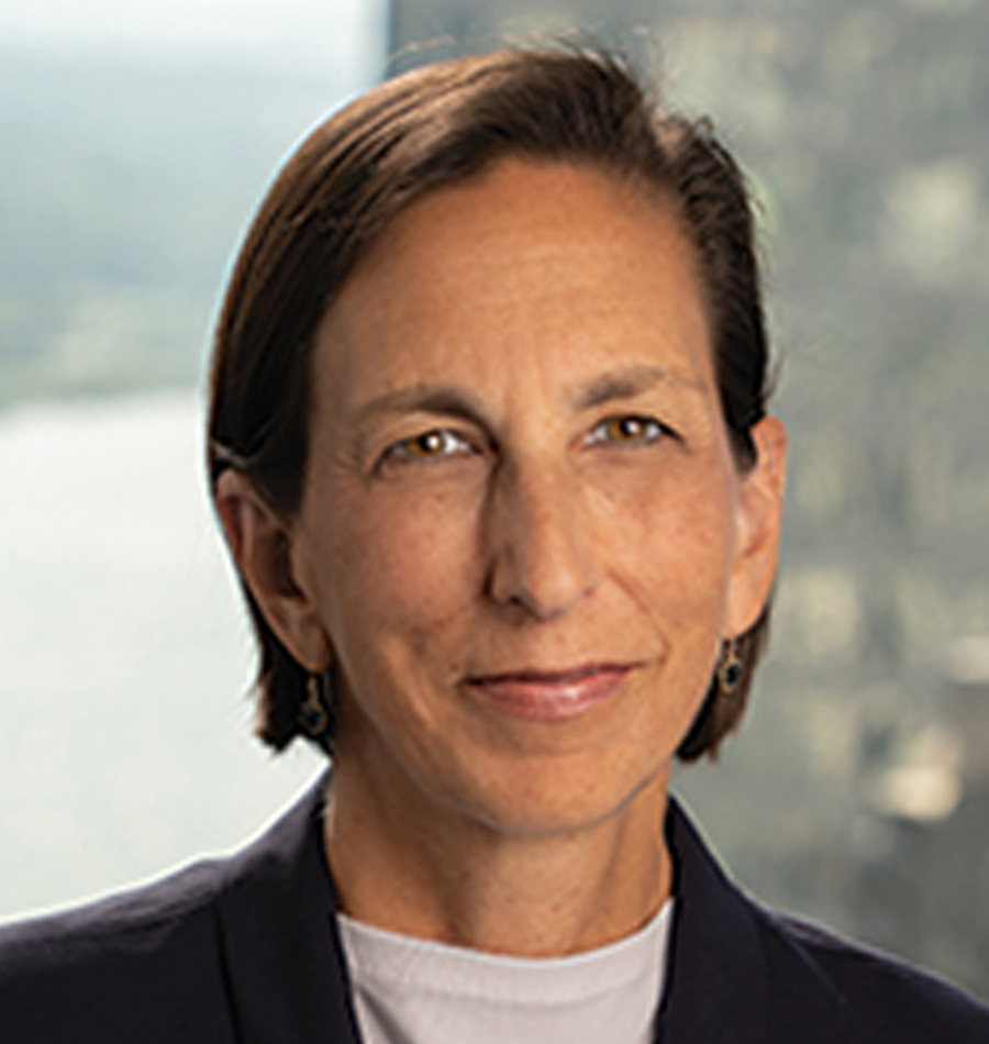 Headshot of Sharon McCarthy smiling in a black business blazer suit