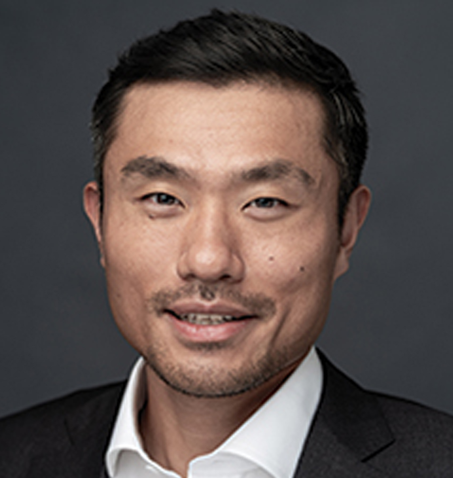Headshot of Zhouzhou (Max) Guo smiling in a black business blazer suit
